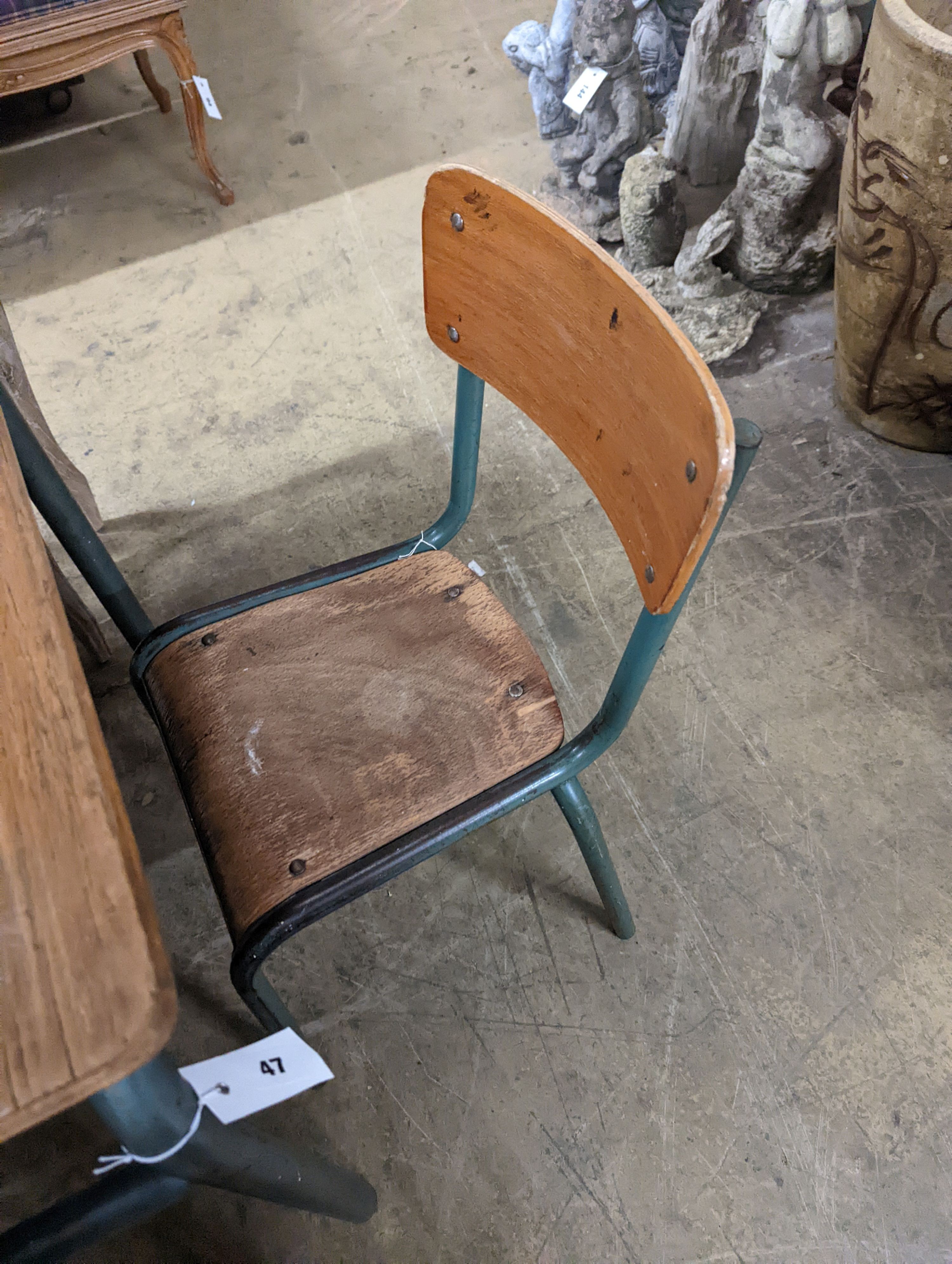 A child's oak and painted metal desk, length 59cm, depth 45cm, height 64cm and a chair